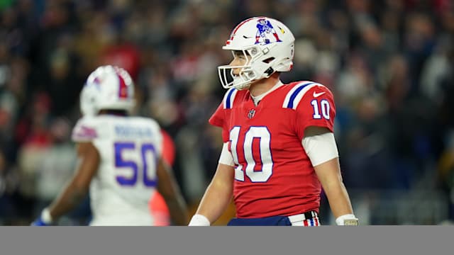 Dec 1, 2022; Foxborough, Massachusetts, USA; New England Patriots quarterback Mac Jones (10) returns to the sideline as they take on the Buffalo Bills in the second quarter at Gillette Stadium.